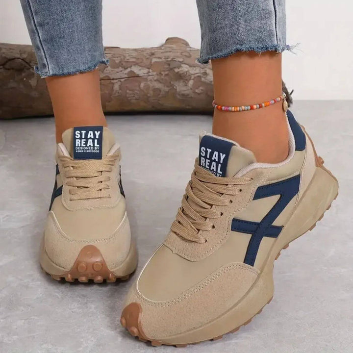 beige orthopedic sneakers with navy accent stripes and chunky rubber sole