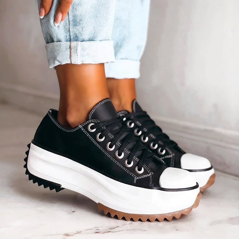 black platform sneakers with white toe cap and chunky gum sole