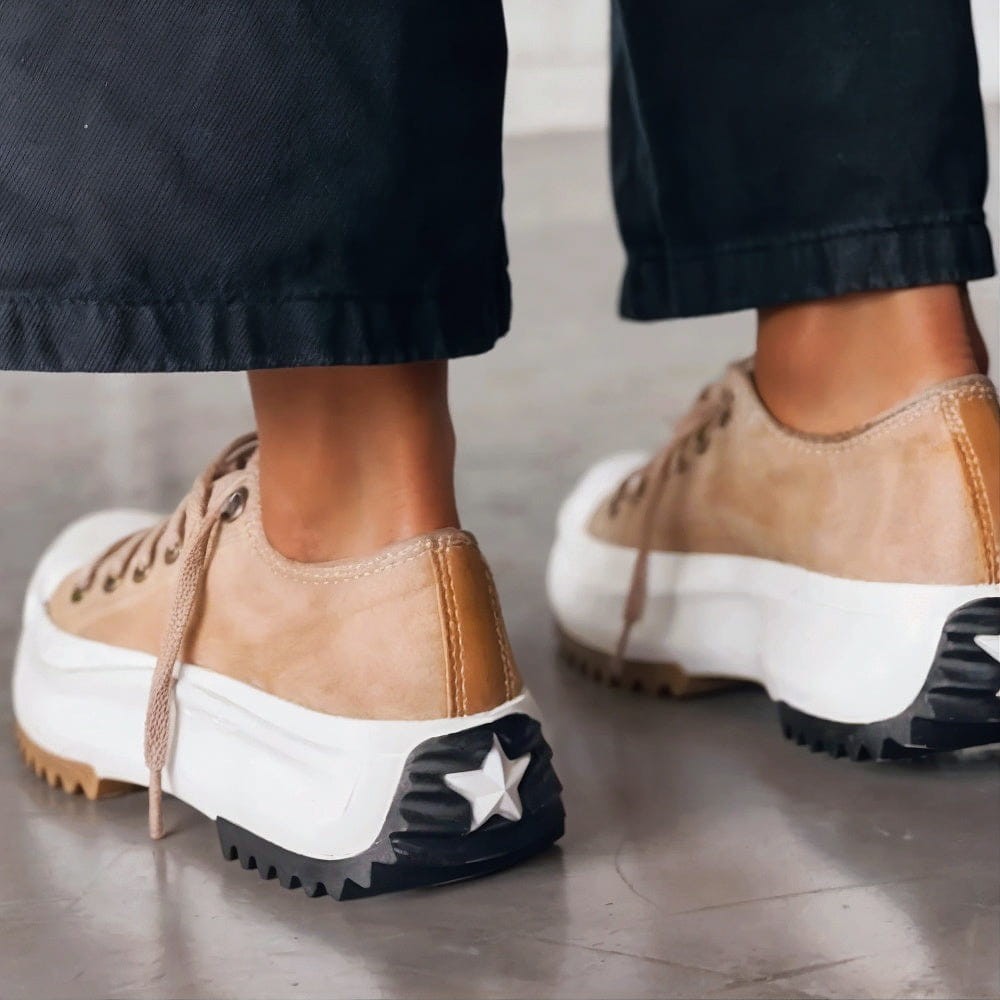 back view of tan platform sneakers with star detail on heel