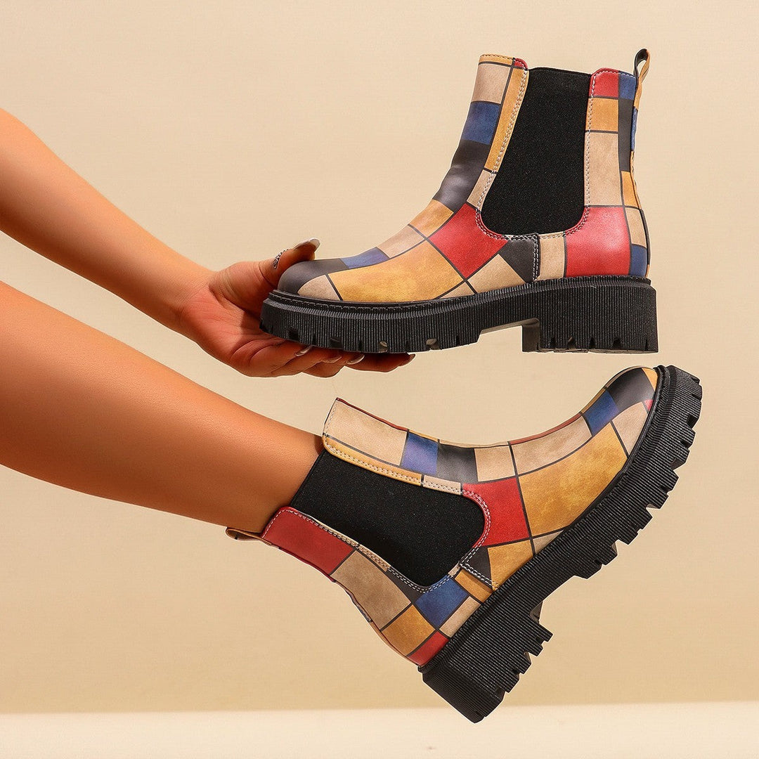 Colorful patchwork Chelsea boots with red, blue, and mustard color blocks