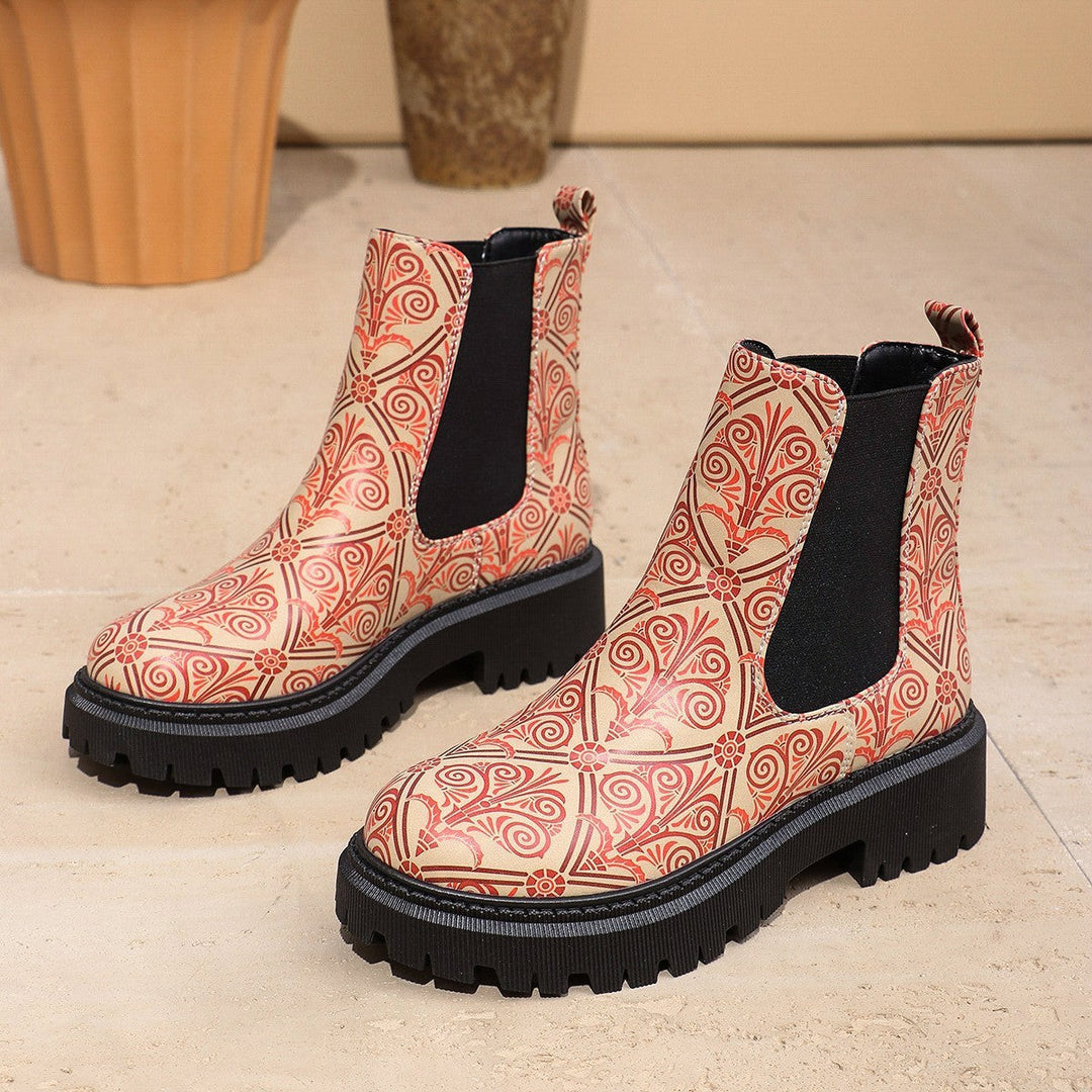 Beige Chelsea boots featuring red mandala-inspired print and platform sole