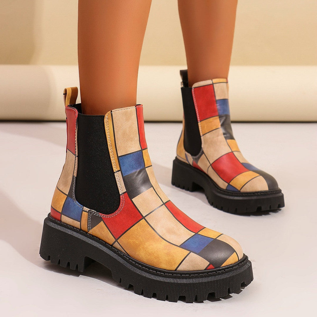 Colorful color-block Chelsea boots with mustard, red, and blue patchwork design