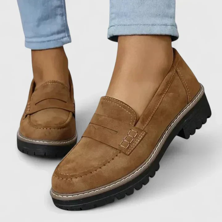 tan suede penny loafers featuring rugged platform sole and topstitching