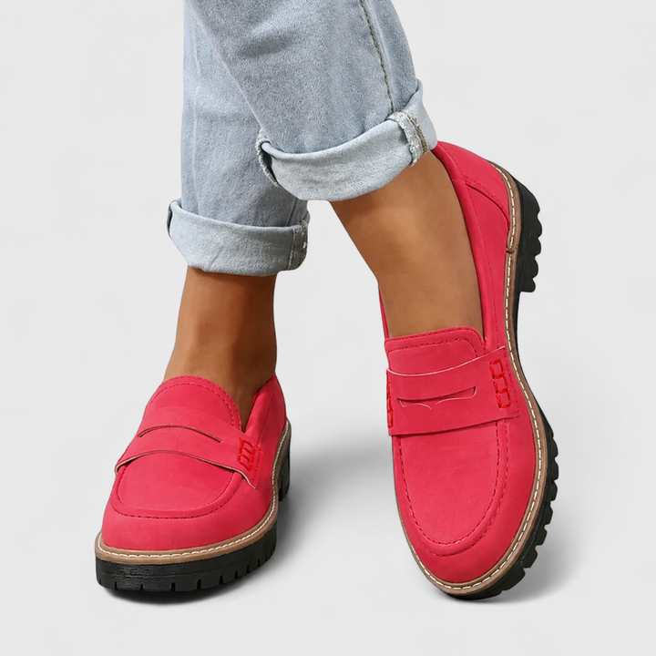 hot pink suede penny loafers worn with rolled-up light denim jeans