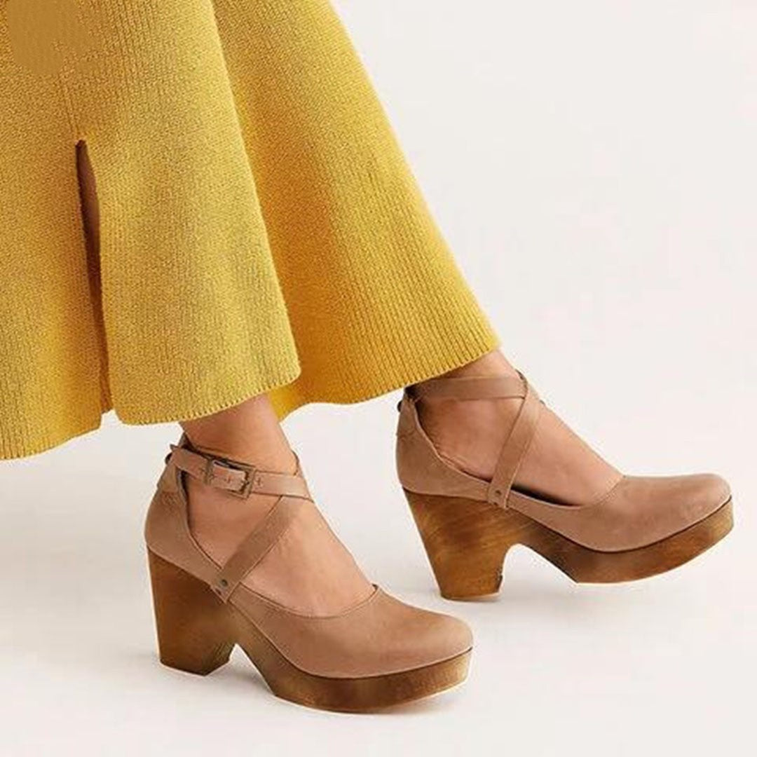 Tan leather wedge booties with crisscross ankle straps and stacked wooden heel