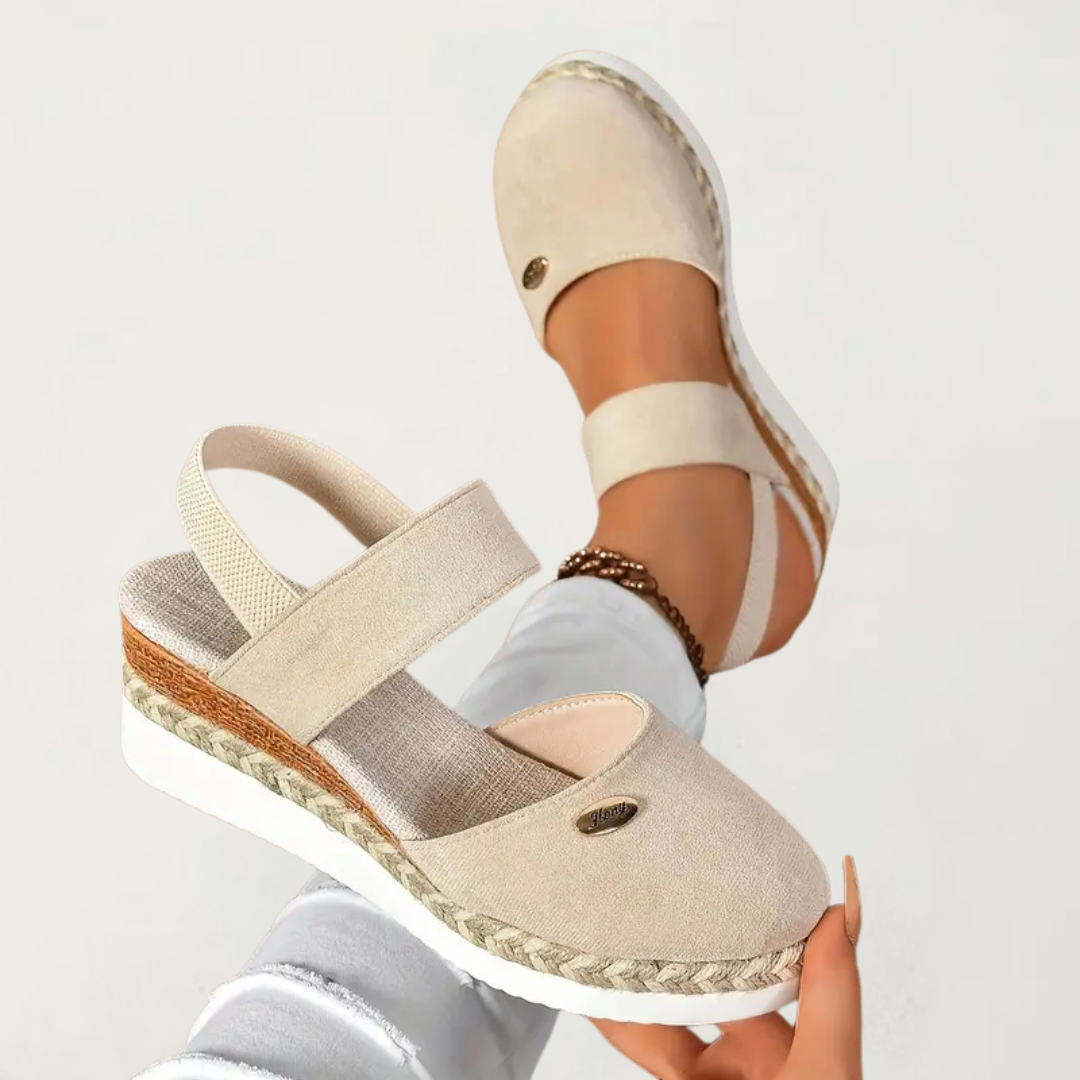 Beige closed-toe espadrille sandal with elastic straps and braided platform sole