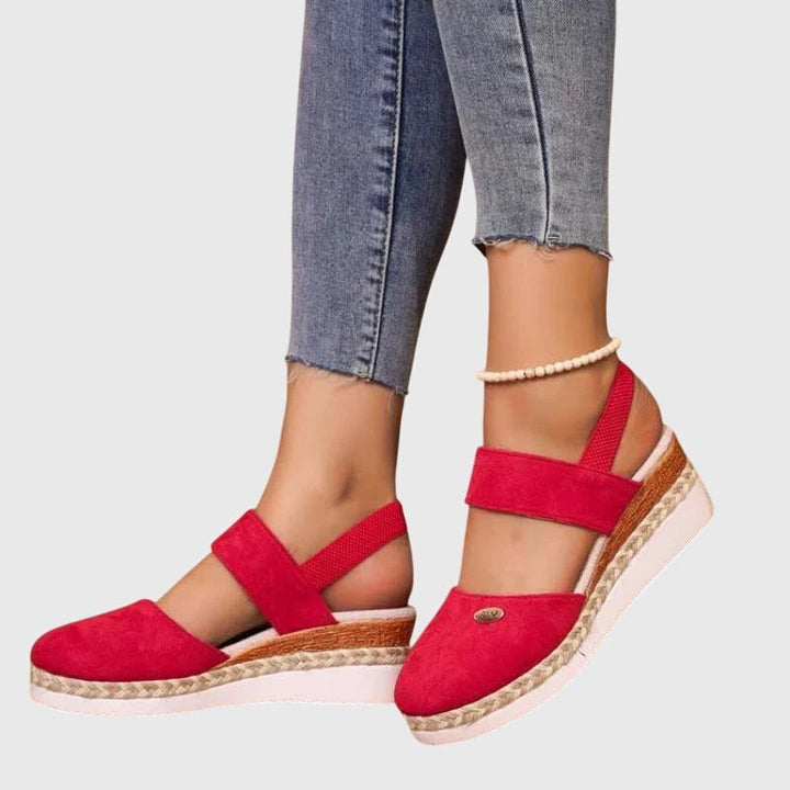 Red suede wedge sandal with elastic ankle strap and braided platform sole