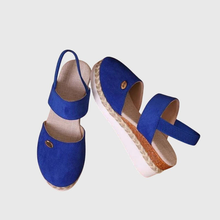 Cobalt blue closed-toe espadrille sandal with elastic strap and platform wedge