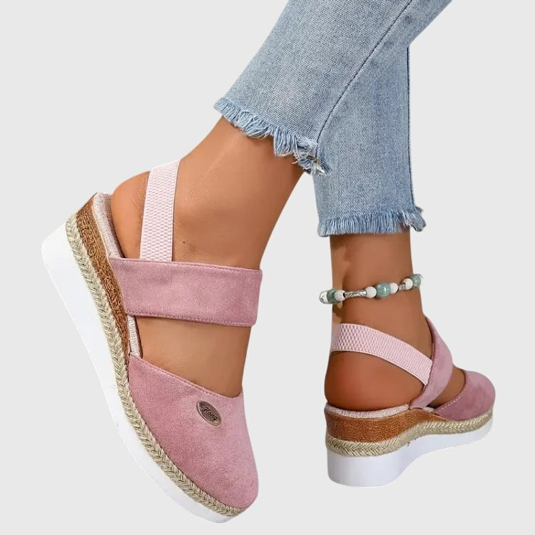 Dusty pink orthopedic sandal with elastic straps and braided espadrille wedge