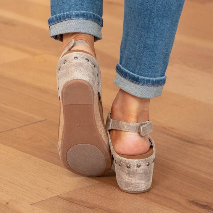 Back view of taupe suede wedge sandals showing rubber tread sole