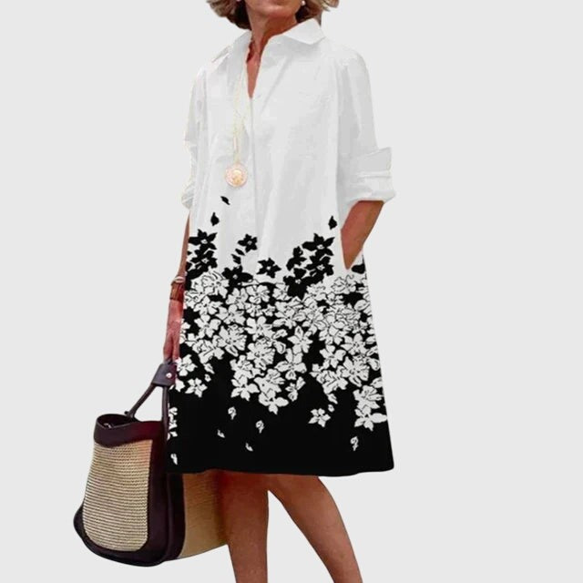 White shirt dress with black floral hem print and rolled cuffs