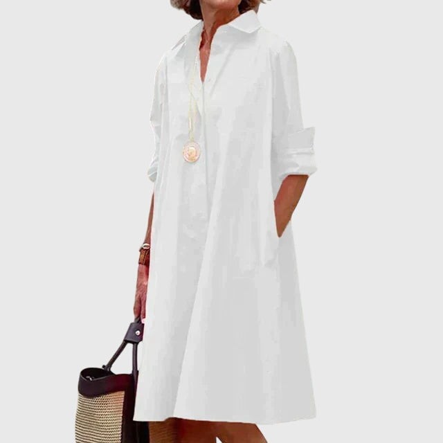 White button-front shirt dress with folded cuffs and flowing knee-length hem