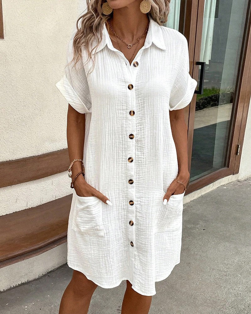 white button-front shirt dress with rolled sleeves and front pockets