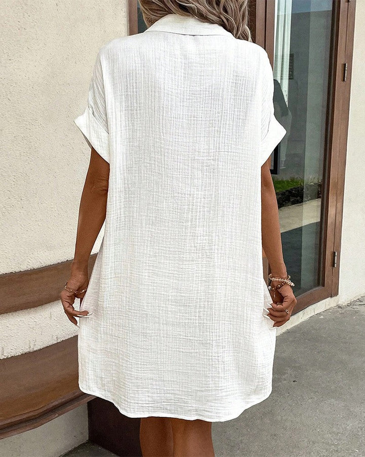 back view of white shirt dress showing collar and relaxed silhouette