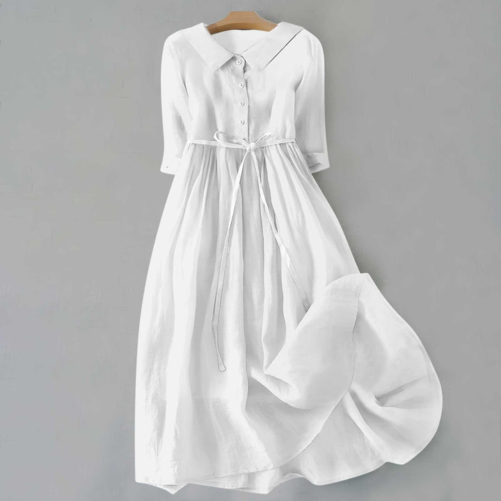 White linen shirt dress with collared neckline and half-length sleeves