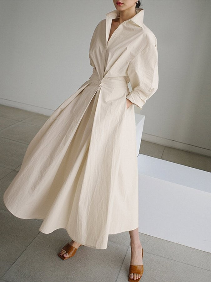 ivory long-sleeve maxi dress with twist-front waist and flowing silhouette