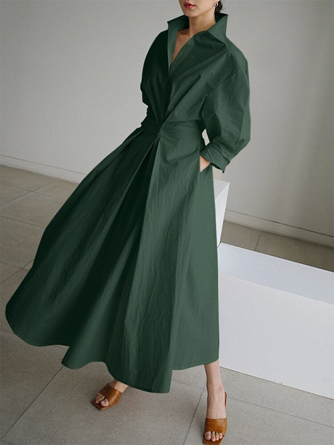 emerald green shirt dress with twist-front waist and swaying pleated hem