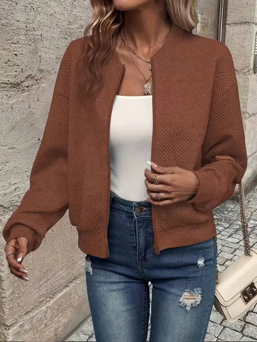 Rust brown textured bomber jacket styled with distressed skinny jeans