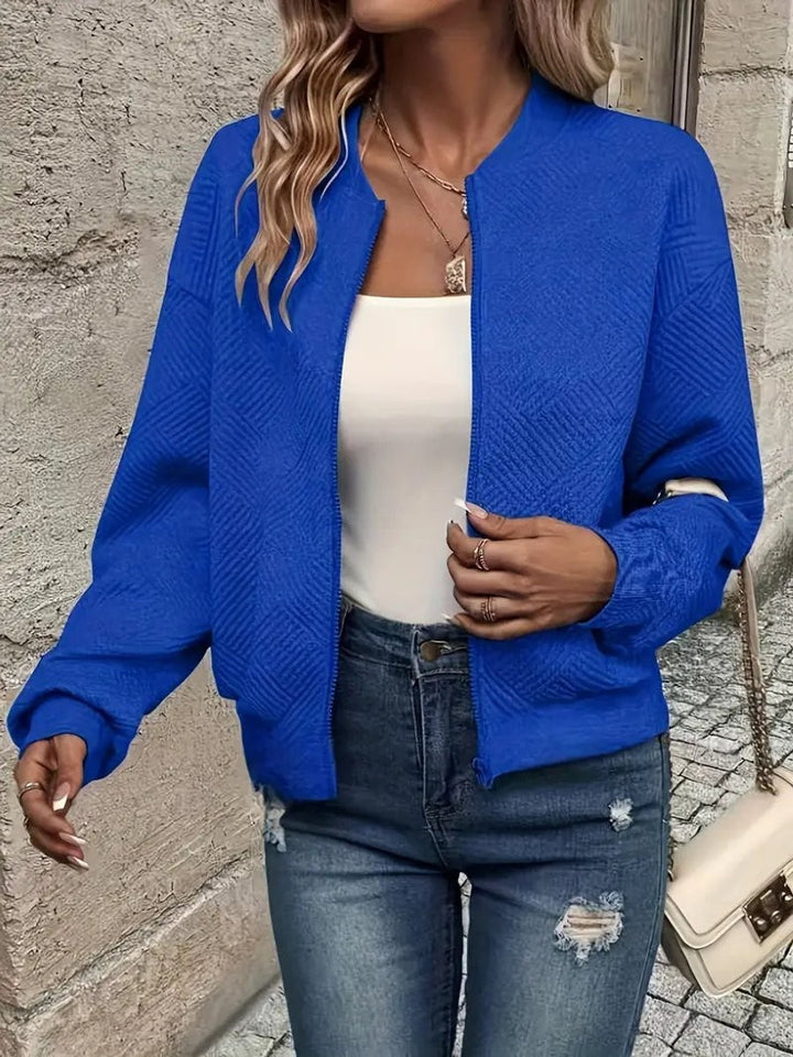 Cobalt blue zip-up bomber jacket featuring a subtle quilted pattern