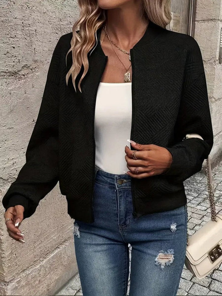 Black quilted-effect cropped bomber jacket styled with ripped denim jeans