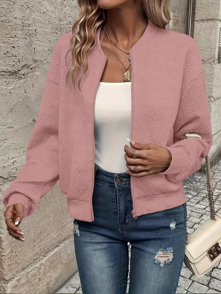 Pink cropped bomber jacket with subtle diamond-quilted texture