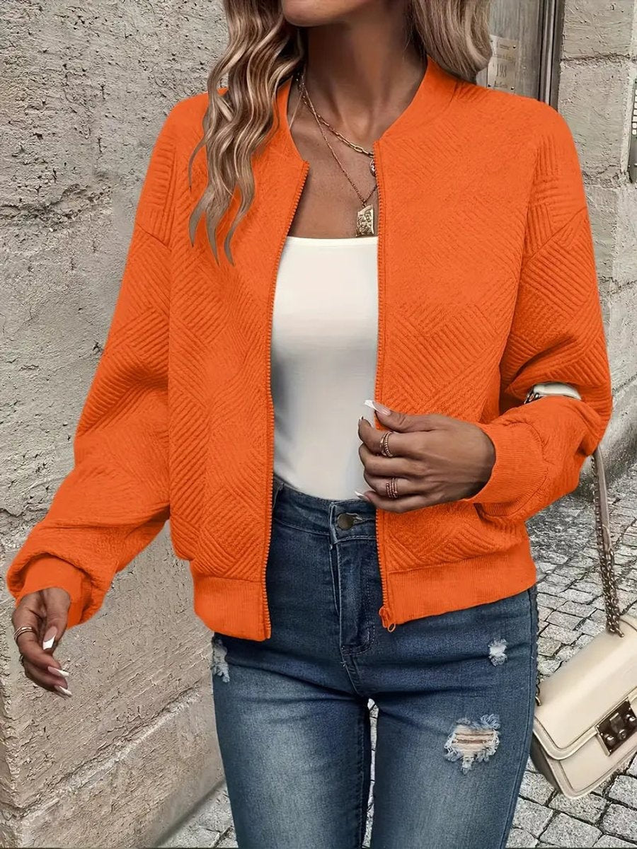 Orange zip-up bomber jacket showcasing a raised geometric weave