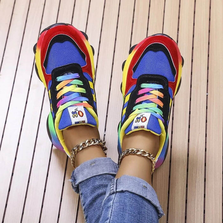 Top-down view of colorful chunky sneakers with tie-dye laces and rainbow sole