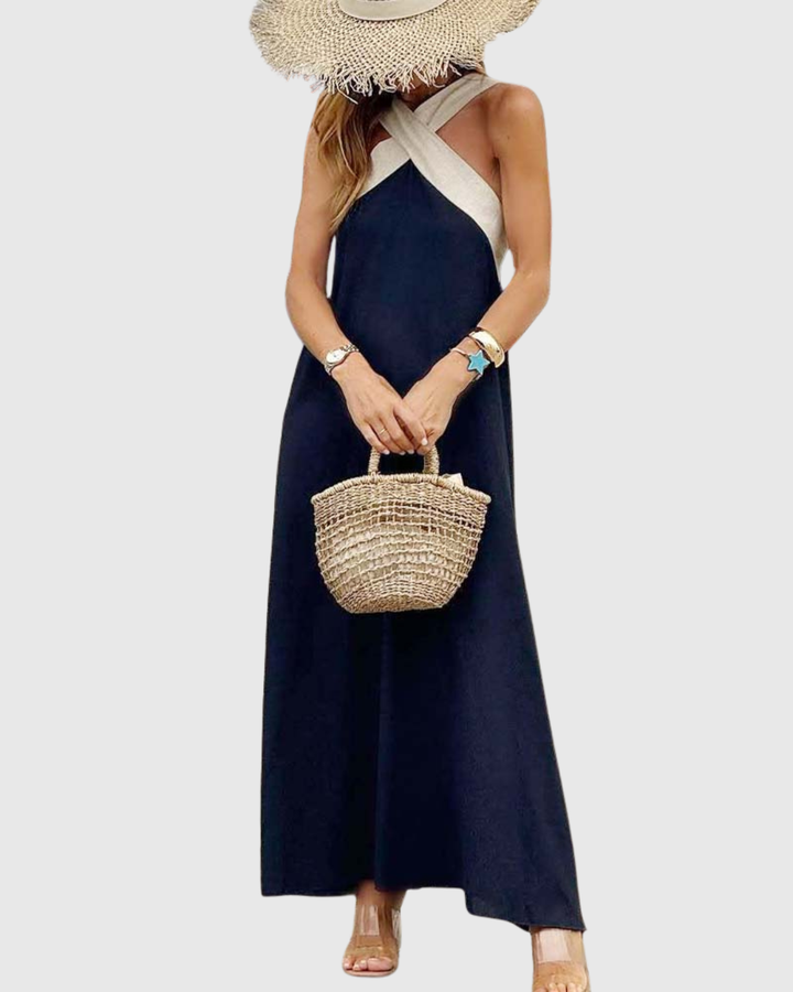 Navy halter maxi dress featuring beige cross-strap neckline detail