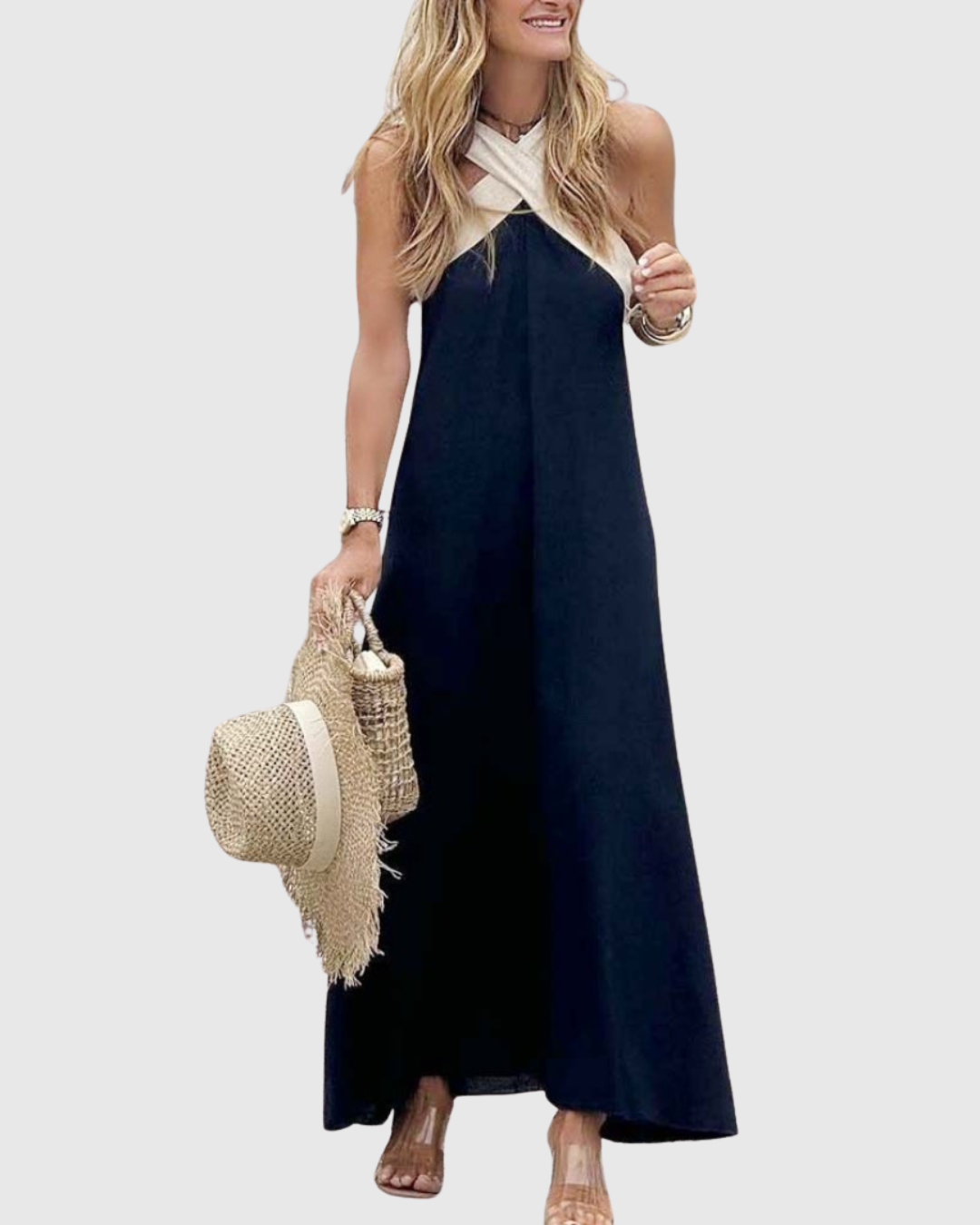 Navy cross-neck maxi dress styled with straw tote and sun hat
