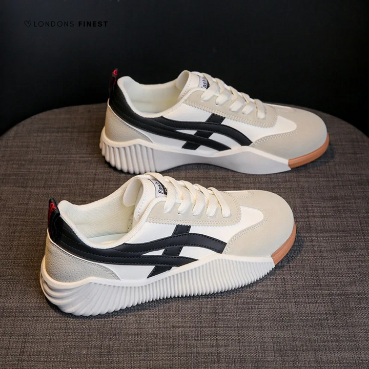 White and black lace-up sneakers with ridged platform sole and gum accents
