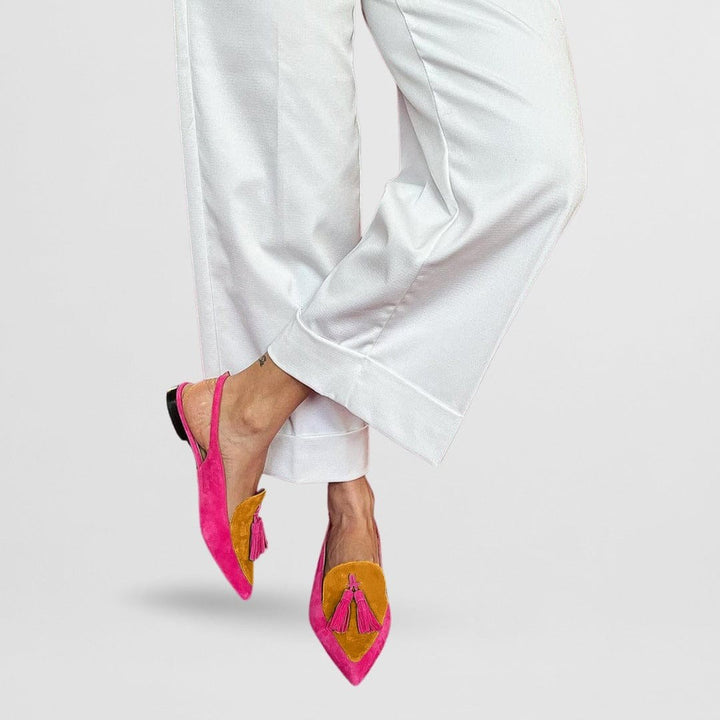 Pink and mustard yellow suede slingback flats featuring pointed toe and tassels