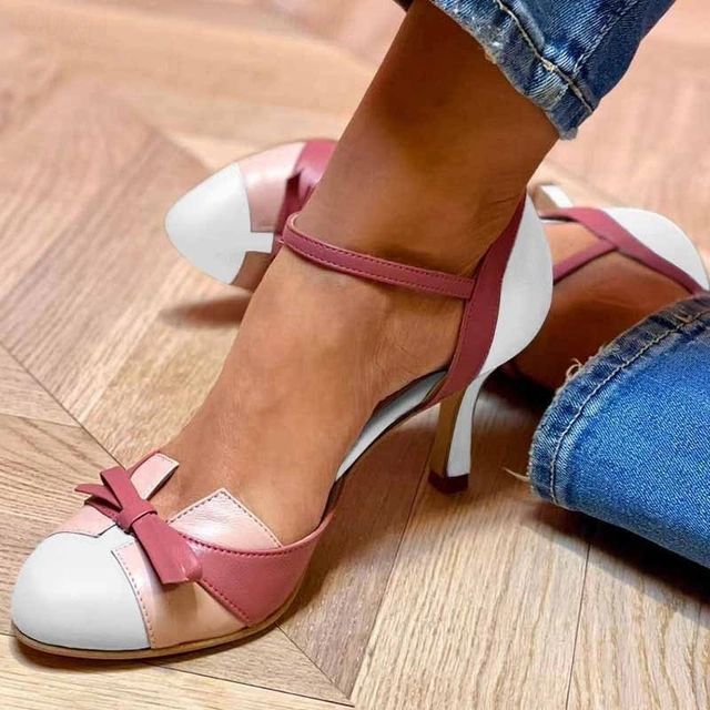 White and mauve two-tone ankle-strap sandals featuring a bow accent on stiletto heel