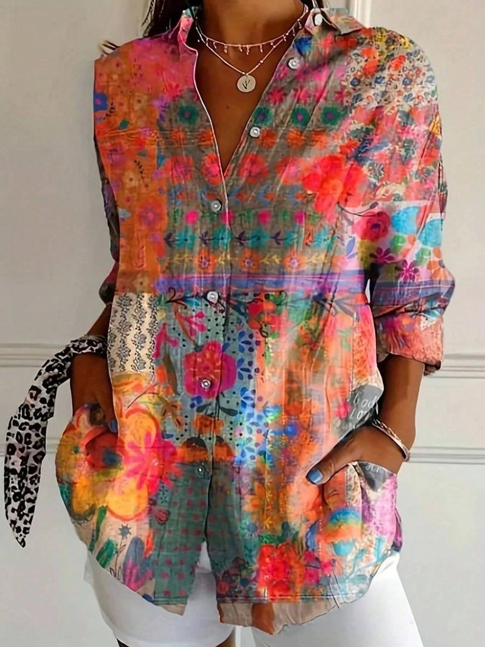 Patchwork floral print blouse featuring mixed pink and orange botanical patterns