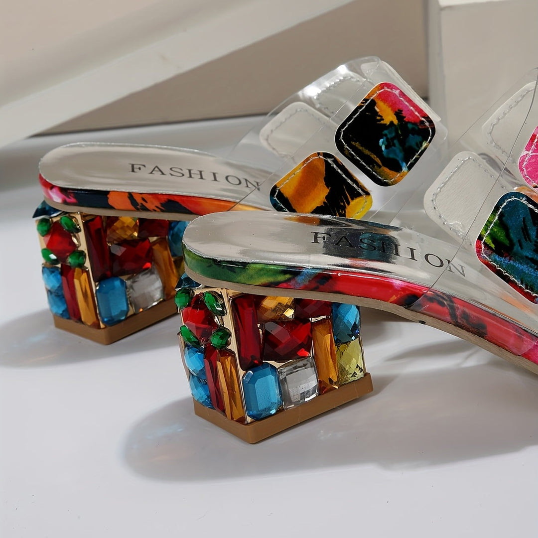 close-up of chunky rhinestone heel on clear strap sandals, colorful gem detail