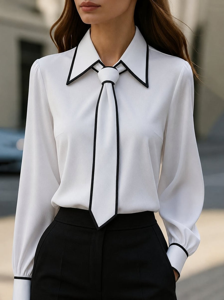 white long-sleeve blouse with black contrast trim and tie-neck detail