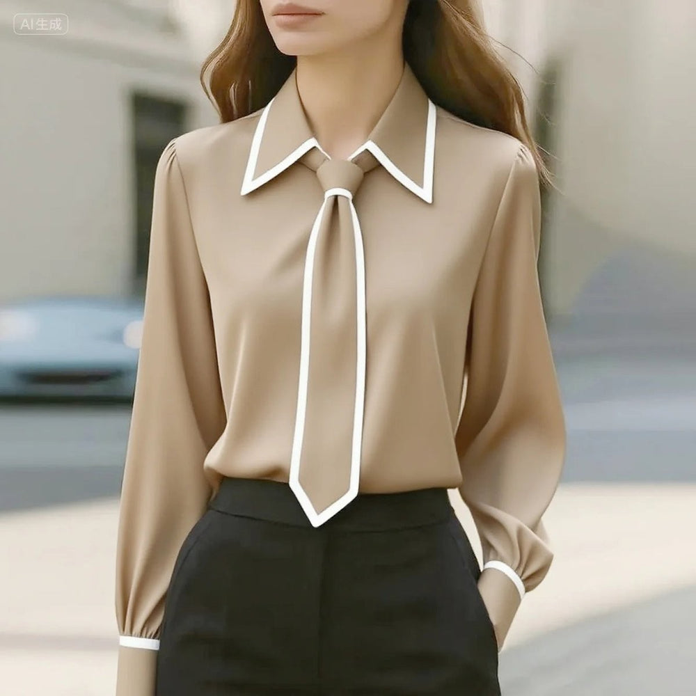 beige button-up blouse featuring white piping and detachable tie collar