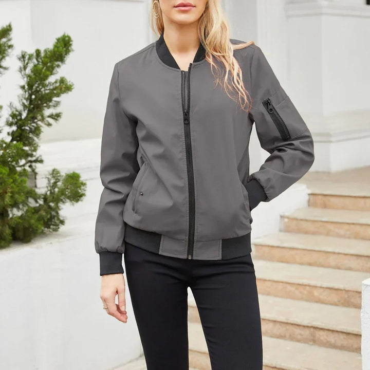 Grey zip-up bomber jacket with black ribbing and arm zip pocket