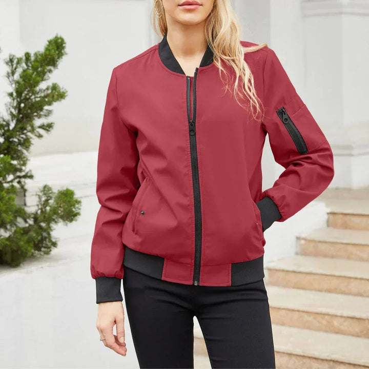Burgundy red bomber jacket with black ribbed cuffs and sleeve pocket