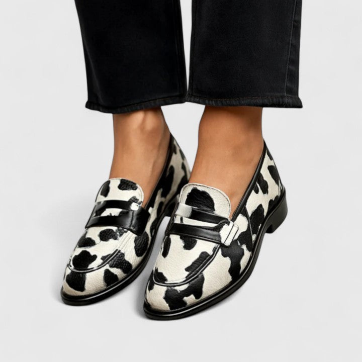 Cow print calf hair penny loafers with black leather trim and low heel