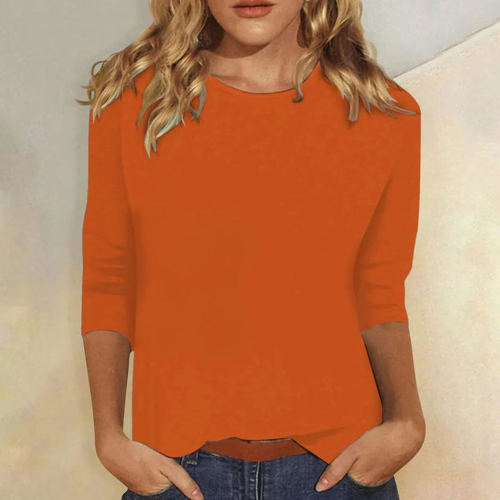orange crew neck top with three-quarter sleeves