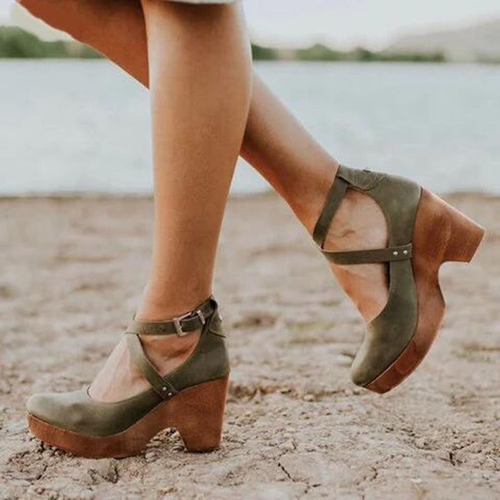 olive green wedge heels with crisscross ankle straps worn outdoors