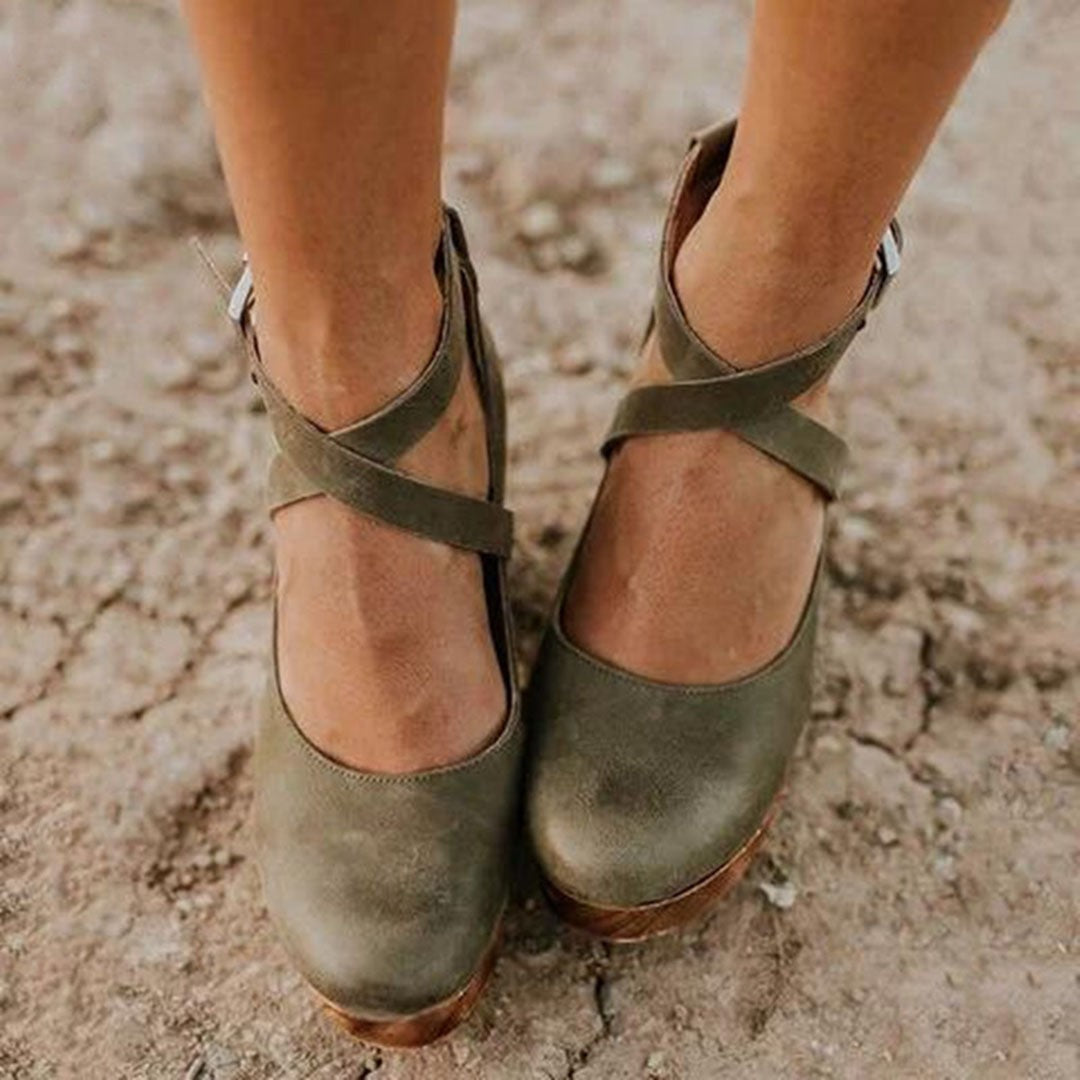 olive suede wedge heels showing crisscross ankle strap detail up close