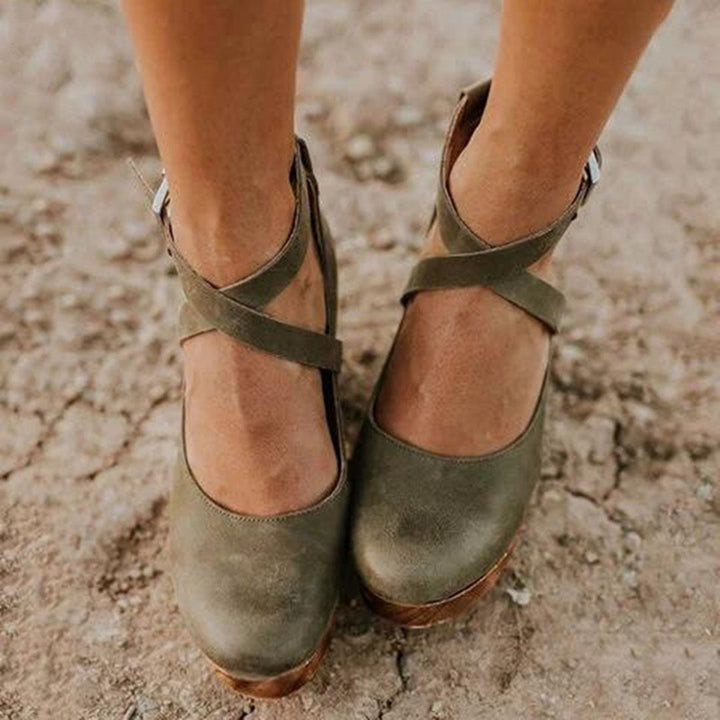 olive suede wedge heels showing crisscross ankle strap detail up close