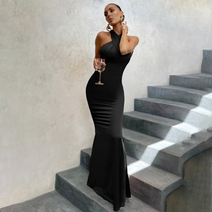Black halter mermaid maxi dress with crisscross neckline and fitted bodice