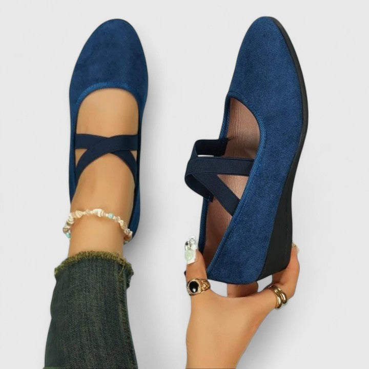 Navy suede wedge flats featuring crossover ankle strap design