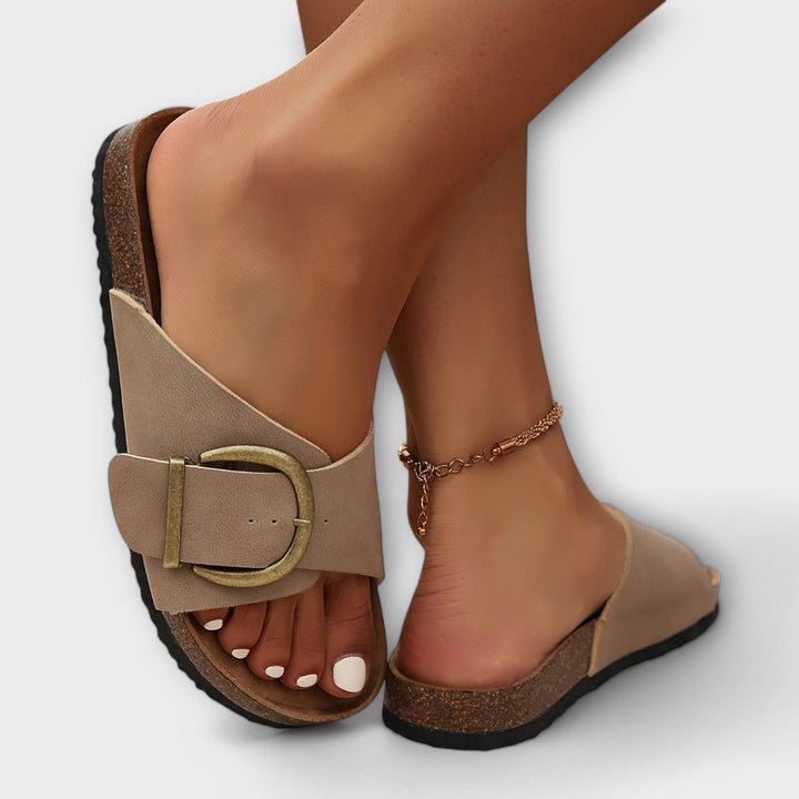 Nude slide sandals with wraparound strap and vintage-style metal buckle
