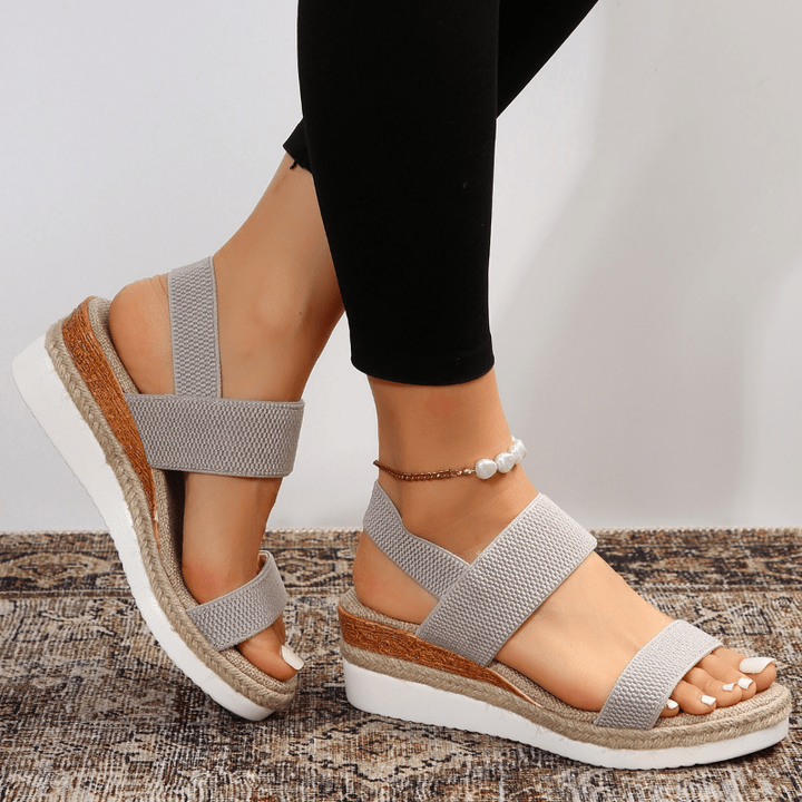 Gray espadrille wedge sandal with crossover straps and beaded ankle bracelet