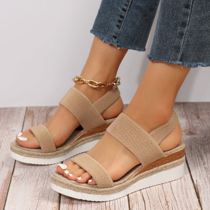 Tan platform wedge sandal featuring woven jute midsole and stretch straps