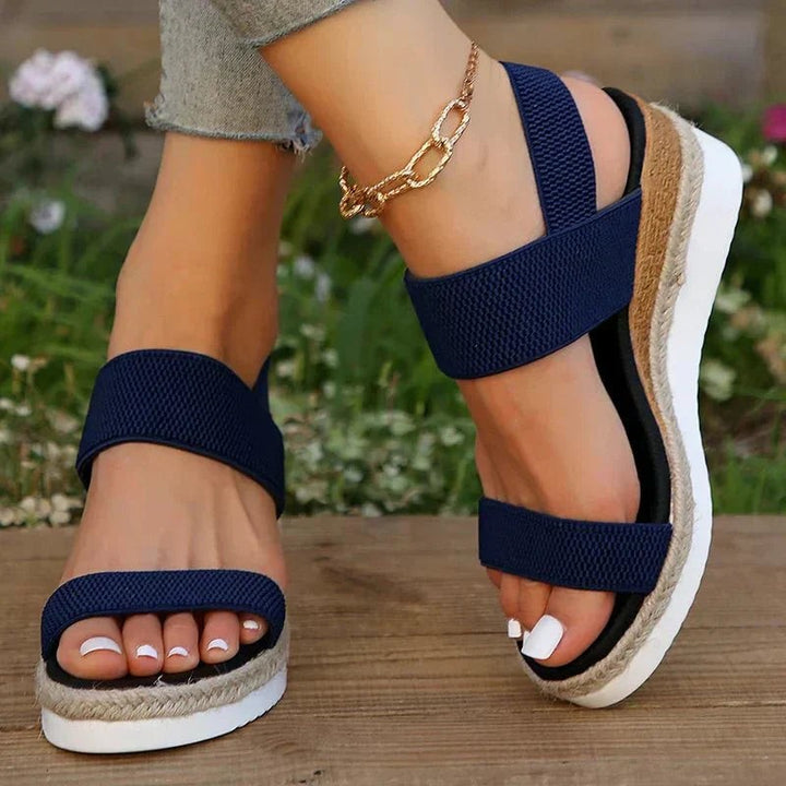 Navy espadrille sandal with wide toe strap and stacked platform heel