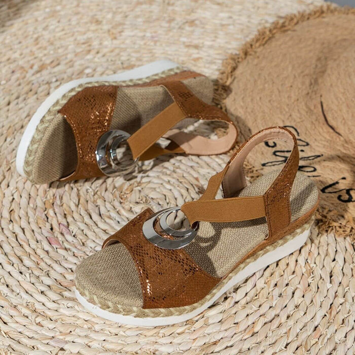 cognac brown wedge sandals with metallic snakeskin straps and braided sole